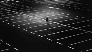 man standing on parking lot